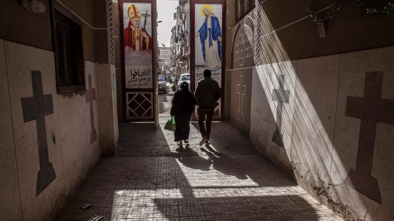 In this Jan. 6, 2015 file photo, Coptic Christians walk outside a church located south of Cairo, Egypt. (AP Photo/Roger Anis, File)