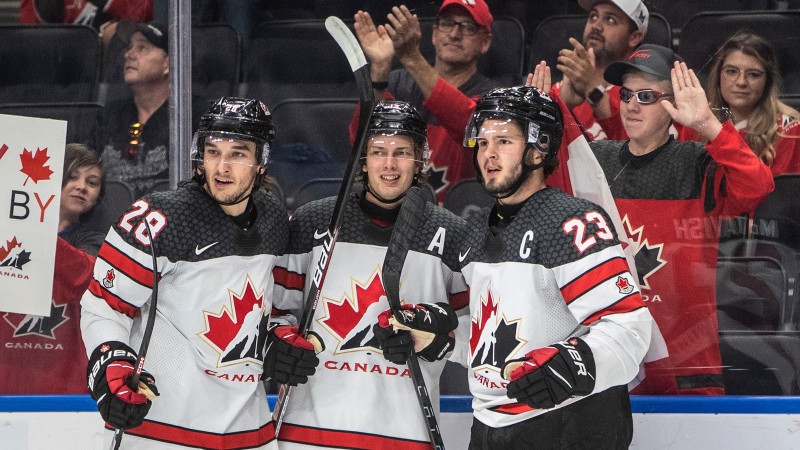 Canada's Ryan O'Rourke (28), Kent Johnson (13) and Mason McTavish (23) celebrate a goal against Slovakia during second period IIHF World Junior Hockey Championship action in Edmonton on Thursday August 11, 2022 (The Canadian Press/Jason Franson).