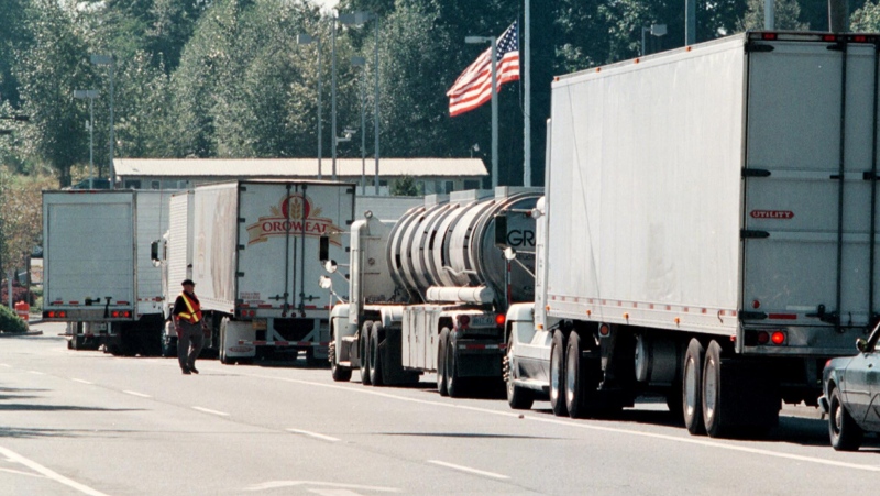 Truck line up at the Pacific Highway Border Crossing on Wednesday Sept. 12, 2001, because of heightened security checks at all border crossings. (CP PHOTO/Richard Lam)