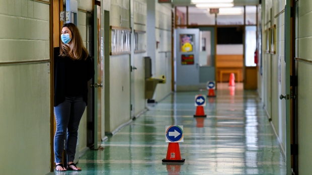 Grade two teacher Vivian Mavraidis looks out into the hallways at Hunter's Glen Junior Public School which is part of the Toronto District School Board (TDSB) during the COVID-19 pandemic in Scarborough, Ont., on Monday, September 14, 2020. THE CANADIAN PRESS/Nathan Denette