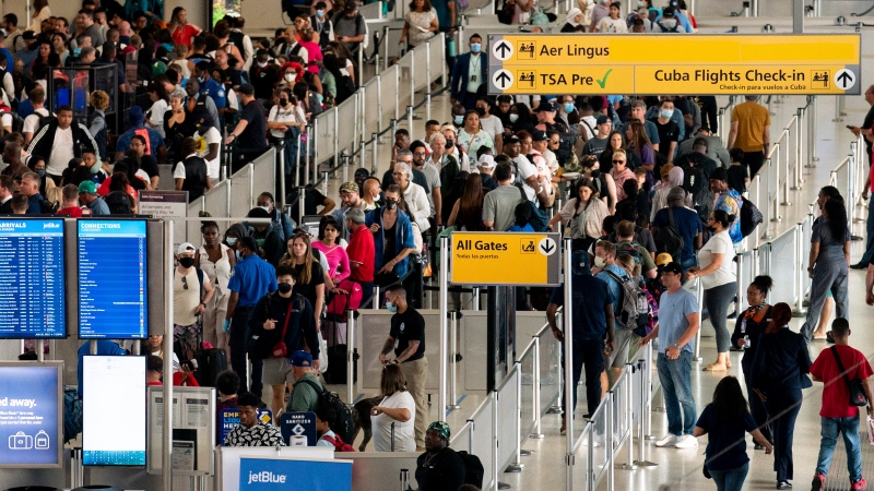 People wait in a TSA line at the John F. Kennedy International Airport on June 28, 2022, in New York. (AP Photo/Julia Nikhinson, File)