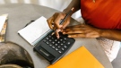 In this undated file photo, a woman is seen using a calculator. (RODNAE Productions/Pexels)