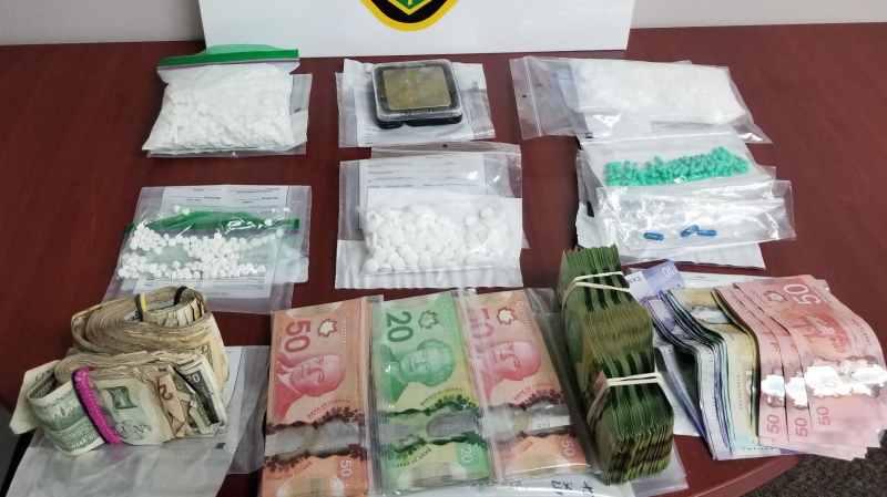Drugs, cash, trafficking paraphernalia and debt list seized in an Aug. 11 search of a West Street home in Hearst. (OPP)