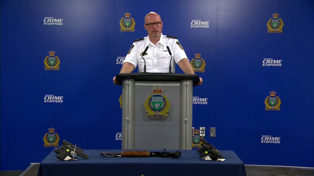 Insp. Elton Hall with the Winnipeg Police Service speaks at a news conference announcing government funding to crack down on firearm trafficking on Aug 16, 2022. On the table in front of him are recently seized firearms with destroyed serial numbers. (CTV News Winnipeg Photo)