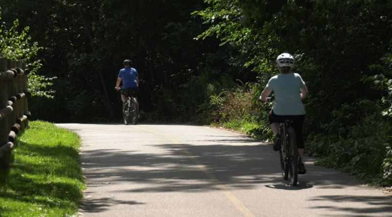 Two cyclists ride the Thames Valley Parkway in Ann Street Park in London, Ont. on August 16, 2022. (Carlyle Fiset/CTV News London)