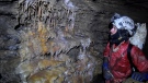 STC member Brendan Moore examines a cave formation. (Credit: Gabriel Kinzler)