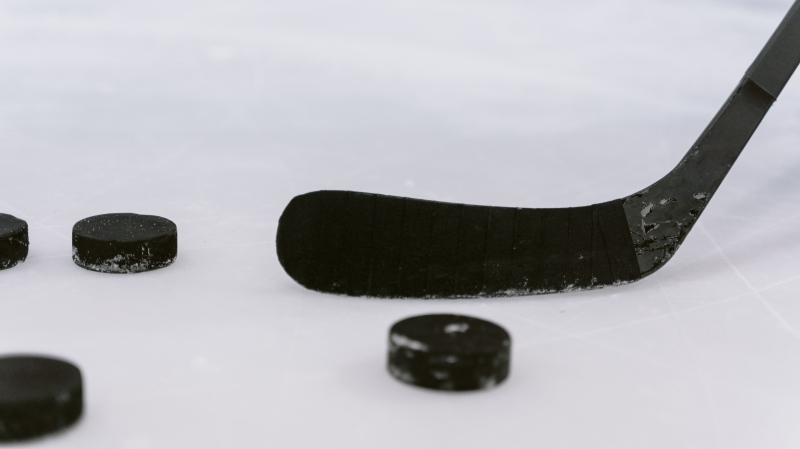 A hockey stick and pucks (Pexels)
