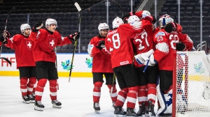 Switzerland celebrates the win over Austria during IIHF World Junior Hockey Championship action in Edmonton on Monday August 15, 2022. THE CANADIAN PRESS/Jason Franson