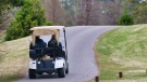 Two people are seen in a golf cart in this undated stock image. (Gene Gallin/Unsplash)