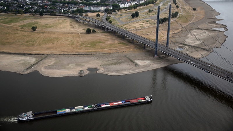 A cargo ship is sailing on the Rhine in Duesseldorf, Germany, Monday, Aug. 15, 2022. (Federico Gambarini/dpa via AP)
