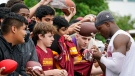 Washington Commanders wide receiver Terry McLaurin, right, signs autographs for fans after practice during NFL football training camp Monday, Aug. 15, 2022, in Ashburn, Va. (AP Photo/Alex Brandon)