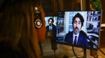 A translator works in their booth as Prime Minister Justin Trudeau appears as a witness via videoconference during a House of Commons finance committee in the Wellington Building on Thursday, July 30, 2020. THE CANADIAN PRESS/Sean Kilpatrick 