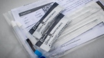 Two COVID-19 rapid tests are displayed at a Fraser Health drive-thru pick up site in Surrey, B.C., on Thursday, January 20, 2022. THE CANADIAN PRESS/Darryl Dyck