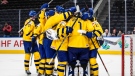 Sweden celebrates the win over Latvia during IIHF World Junior Hockey Championship quarterfinal action in Edmonton on Wednesday August 17, 2022. (THE CANADIAN PRESS/Jason Franson)