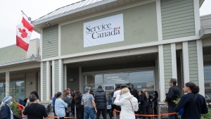 People line up at the passport office, Tuesday, June 21, 2022 in Laval, Que. THE CANADIAN PRESS/Ryan Remiorz 
