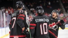 Canada's Will Cuylle (27), Logan Stankoven (10) and Donovan Sebrango (7) celebrate a goal against Switzerland during second period IIHF World Junior Hockey Championship quarterfinal action in Edmonton on Wednesday August 17, 2022. THE CANADIAN PRESS/Jason Franson