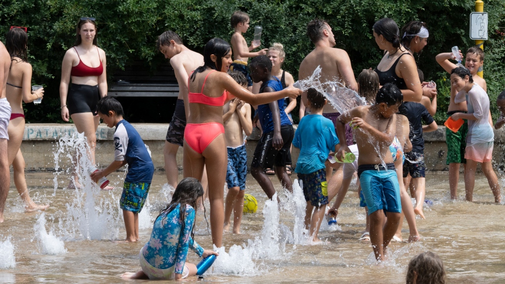 People cool off at a splash pad