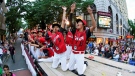 The Canada Region champion Little League team from Vancouver, British Columbia, rides in the Little League Grand Slam Parade in downtown Williamsport, Pa., Monday, Aug. 15, 2022. (AP / Gene J. Puskar)