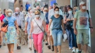 People wear face masks as they walk through a Metro station in Montreal. (THE CANADIAN PRESS/Graham Hughes)