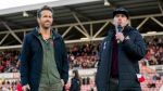 This image released by FX shows Ryan Reynolds, left, and Rob McElhenney in a scene from the docuseries "Welcome to Wrexham," which follows Reynolds and McElhenney as they takeover the lower-league Welsh soccer team Wrexham AFC. (Patrick McElhenney/FX via AP)