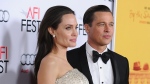 Angelina Jolie, left, accused Brad Pitt of injuring her and verbally abusing their children during a heated encounter aboard a private jet in 2016, according to an FBI report. Jolie and Pitt are pictured here in 2015. (Jason LaVeris/FilmMagic/Getty Images)