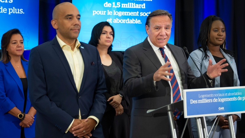 Quebec Premier Francois Legault surrounded by CAQ candidates in the future Quebec election speaks to the press in Laval, Quebec on Friday, August 12, 2022. THE CANADIAN PRESS/Peter McCabe
