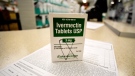 A box of ivermectin is shown in a pharmacy as pharmacists work in the background, Sept. 9, 2021, in Georgia. (AP Photo/Mike Stewart)