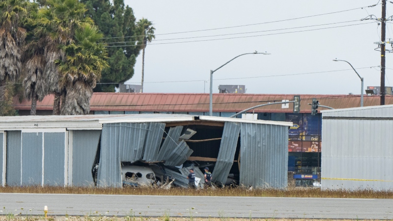 Emergency personnel investigate the wreckage of a plane crash at Watsonville Municipal Airport in Watsonville, Calif., Thursday, Aug. 18, 2022. (AP Photo/Nic Coury)