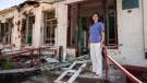 Dr. Ilona Butova stands in front of the therapy department which was destroyed after a Russia attack on the hospital in Zolochiv, Kharkiv region, Ukraine, Sunday, July 31, 2022. (AP Photo/Evgeniy Maloletka)