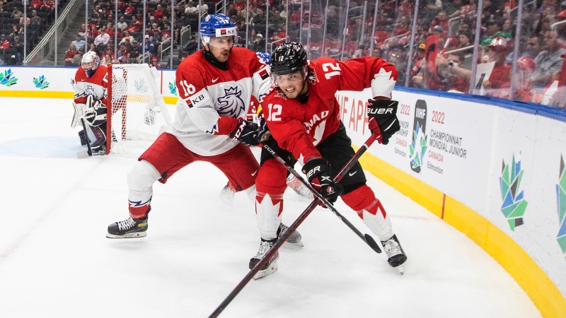 Canada's Tyson Foerster (12) and Czechia's Matous Mensik (18) battle for the puck during second period IIHF World Junior Hockey Championship action in Edmonton on Saturday August 13, 2022. THE CANADIAN PRESS/Jason Franson