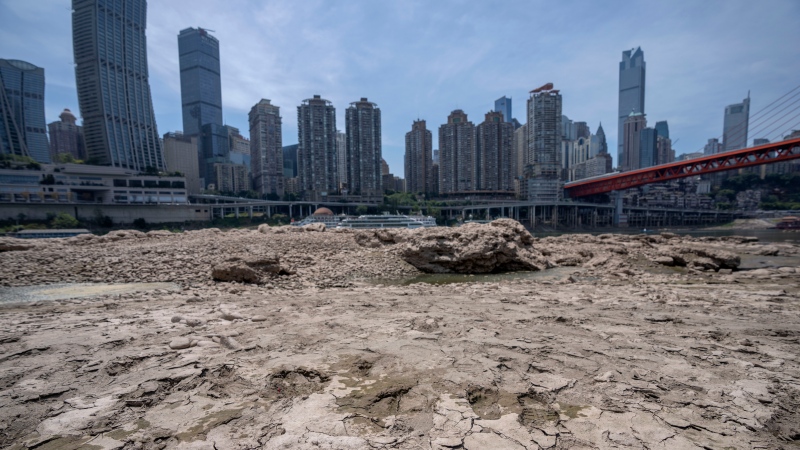 FILE - Cracks in dried mud are seen on a portion of the dry riverbed of the Jialing River in southwestern China's Chongqing Municipality, Friday, Aug. 19, 2022. (AP Photo/Mark Schiefelbein)