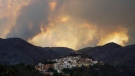 Clouds of smoke cover the sky during a wildfire near Bejis, eastern Spain, on Wednesday, Aug. 17, 2022. (AP Photo/Alberto Saiz)