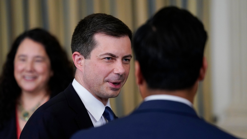 Transportation Secretary Pete Buttigieg arrives before President Joe Biden and signs the Democrats' landmark climate change and health care bill in the State Dining Room of the White House in Washington, Tuesday, Aug. 16, 2022. (AP Photo/Susan Walsh)