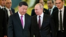 Chinese President Xi Jinping, centre left, and Russian President Vladimir Putin, centre right, enter a hall for talks at the Kremlin in Moscow June 5, 2019.