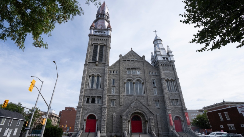 A person rides their bike past a decommissioned church, Thursday, August 18, 2022 in Ottawa. THE CANADIAN PRESS/Adrian Wyld