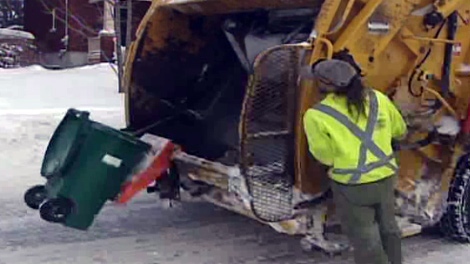 City workers pick up green bins in Ottawa, marking the start of the city's composting program, Monday, Jan. 4, 2010.
