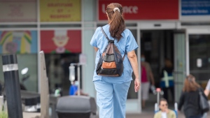 A healthcare worker is shown outside a hospital in Montreal, Thursday, July 14, 2022, as the COVID-19 pandemic continues in the province. Over 7000 healthcare workers are off the job due to COVID-19 related reasons. THE CANADIAN PRESS/Graham Hughes