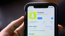 This July 30, 2019, file photo shows an introduction page for Snapchat shown in a mobile phone displayed at Apple's App Store in Chicago. (AP Photo/Amr Alfiky, File)