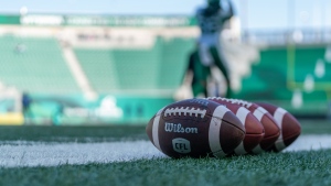 Footballs sits on the field before preseason CFL football action as the Saskatchewan Roughriders plays the Winnipeg Blue Bombers at Mosaic Stadium in Regina, Sask., on Tuesday, May 31, 2022. THE CANADIAN PRESS/Heywood Yu