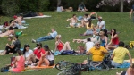People enjoy a warm sunny day in a city park in Montreal. (THE CANADIAN PRESS/Graham Hughes)