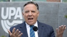 CAQ Leader François Legault speaks to reporters while campaigning Wednesday, September 7, 2022 in Montreal. (THE CANADIAN PRESS/Ryan Remiorz)