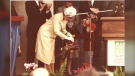 Supplied image of Landon presenting the flowers to Queen Elizabeth II.