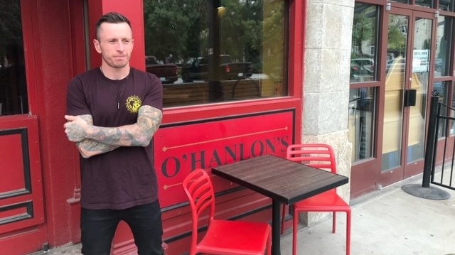 Andrew Shanks, the general manager of O'Hanlon's, stands near the door where thieves have broken glass three times since July. (StefanieDavis/CTVNews) 