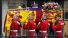 Pallbearers carry the coffin of Queen Elizabeth II, draped in the Royal Standard with the Imperial State Crown during her State Funeral at Westminster Abbey in London, Monday, Sept. 19, 2022. The Queen, who died aged 96 on Sept. 8, will be buried at Windsor alongside her late husband, Prince Philip, who died last year. THE CANADIAN PRESS/AP-James Manning/Pool Photo via AP