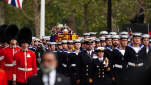 The coffin of Queen Elizabeth II is pulled following her funeral service in Westminster Abbey in central London, Monday, Sept. 19, 2022. (Martin Rickett/Pool Photo via AP)