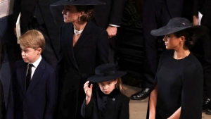 Catherine, Princess of Wales (back left) and Meghan, the Duchess of Sussex (right), arrive at Westminster Abbey with Catherine's children Prince George and Princess Charlotte. (Phil Noble/Pool/AP)