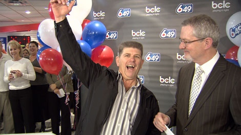 Karl Hoolsema of Aldergrove, B.C., cheers after being handed a cheque for 6.7 million.