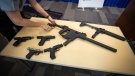 Seized firearms are displayed during an RCMP and Crime Stoppers news conference at RCMP headquarters in Surrey, B.C., on Monday, May 17, 2021. THE CANADIAN PRESS/Darryl Dyck