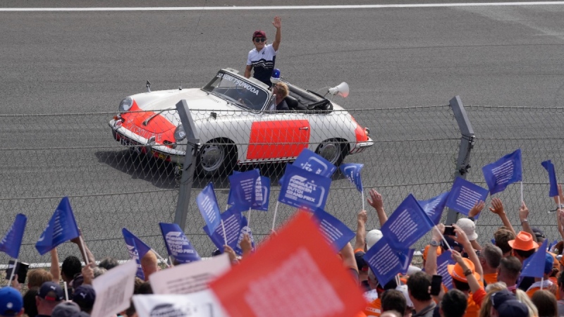 Alpha Tauri driver Yuki Tsunoda of Japan waves to the fans during the drivers' parade before the Formula One Dutch Grand Prix at the Zandvoort racetrack, on Sept. 4, 2022. (Peter Dejong / AP)