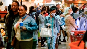 Customers, some wearing face masks to protect against the spread of the coronavirus, patronize the Reading Terminal Market in Philadelphia, Friday, April 22, 2022. (AP Photo/Matt Rourke)